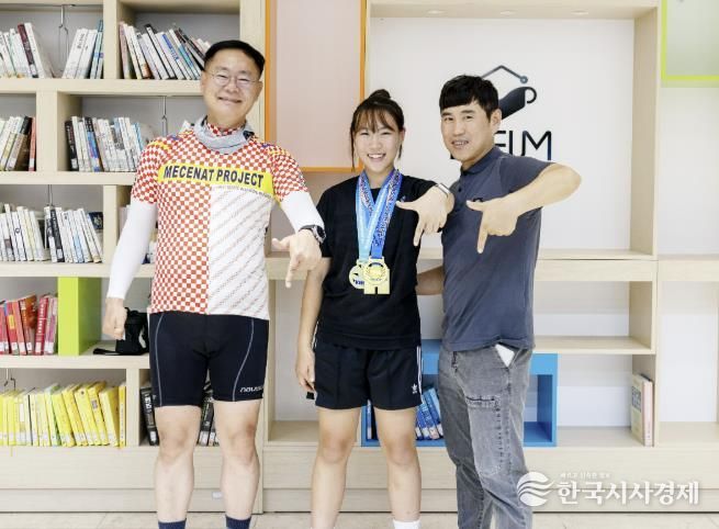 퇴근길에 응원 온 군수와 함께”김재욱 칠곡군수(왼쪽)가 퇴근길에 전국레슬링대회 3연속 우승을 차지한 약동초 6학년 임하경 양(가운데)을 격려하고 있다. 오른쪽은 아버지 임종구 씨.