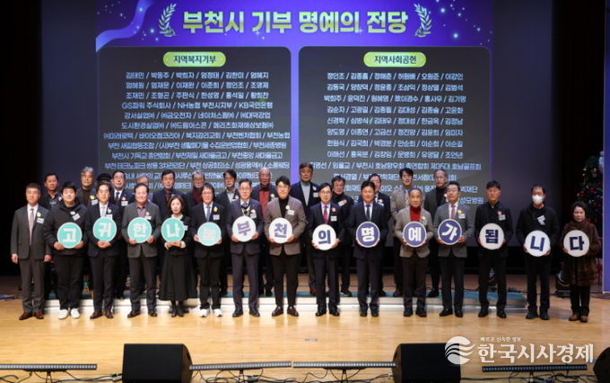 명예의 전당 등재자들과 부천시장이 종무식 무대에서 기념사진을 찍고 있다.