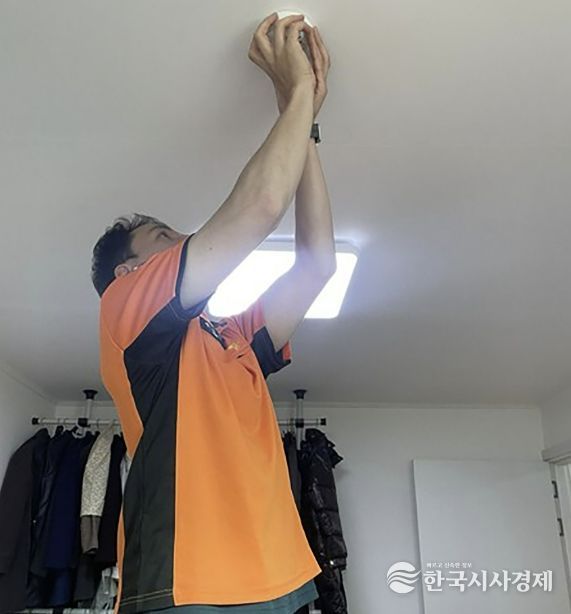 소방관계자가 주택에 화재감지기를 설치하는 모습